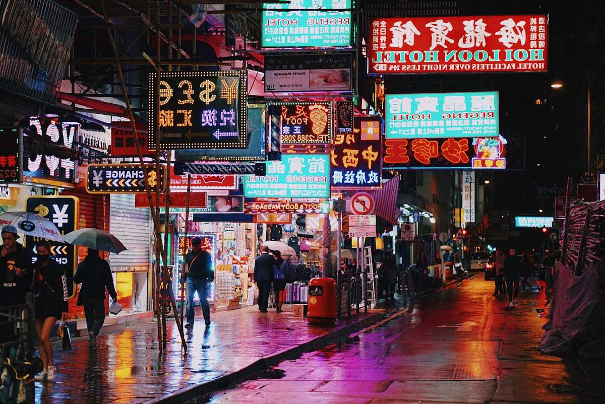 urban people walking on side of road neon